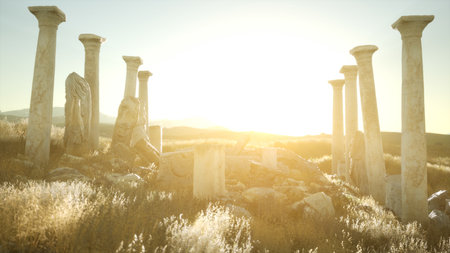 Ancient stone columns rise from a grassy hilltop, illuminated by warm sunlight. A tranquil atmosphere surrounds this historical site, inviting exploration and reflection in natures embrace.の写真素材