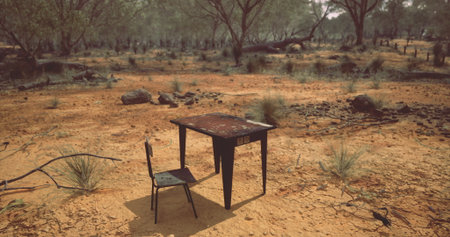 In a desolate landscape, a weathered table and chair sit forlornly on dry ground surrounded by...