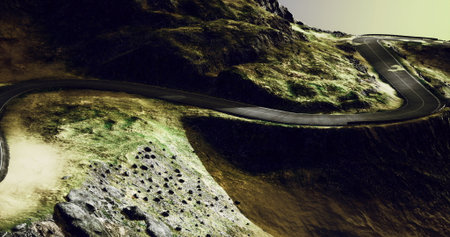 A serpentine road meanders through rugged hills and craggy rocks, bathed in the soft glow of...