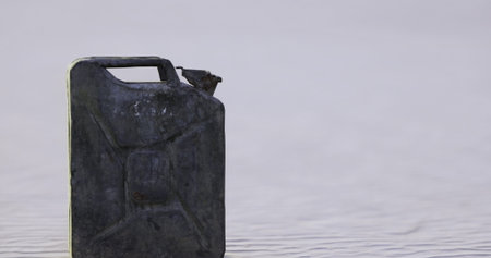 A solitary canister stands on a tranquil shoreline as twilight approaches, reflecting the soft hues of the fading light on the waters surface, evoking a sense of stillness and nostalgia.の写真素材
