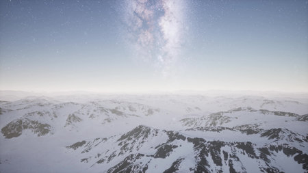 Snowy mountain peaks stretch across the horizon as the magnificent Milky Way illuminates the night...