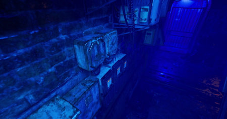 An atmospheric urban alleyway is illuminated with a soft blue light, showcasing aged electrical...