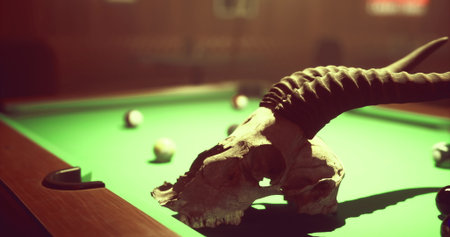 A rustic billiard table is adorned with a cow skull and scattered pool balls, creating an intriguing...