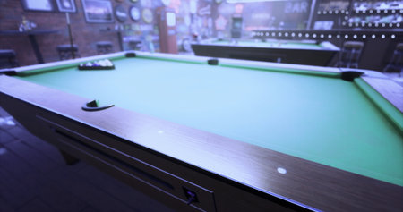 Players eagerly prepare for a game of billiards in a warm, welcoming bar. The atmosphere is lively,...