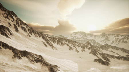 Glistening snow capped peaks rise majestically against a backdrop of vibrant skies at dawn, as warm...
