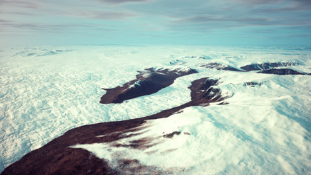 An aerial view of a mountain range covered in snow