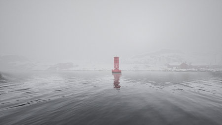 A red metal buoy floats on top of the cold Norwegian sea.の写真素材