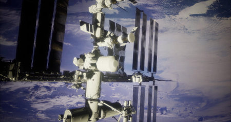 A space station is seen floating in low Earth orbit, surrounded by the blue of the planet and wispy...