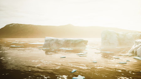 Golden light breaks over an icy seascape, illuminating large icebergs floating in tranquil waters....