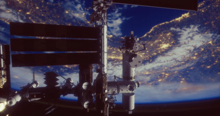 The International Space Station in orbit above Earth, showcasing city lights below and the curve of...