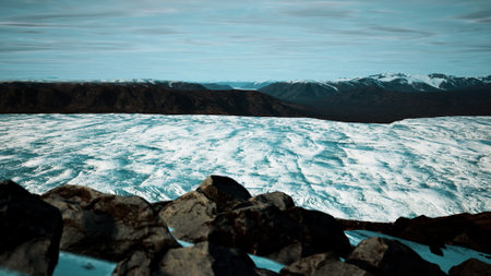 Atop a rocky vantage point, a breathtaking glacier stretches across the valley, reflecting soft blue...