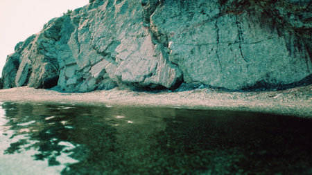 A massive rock perched on a pristine beach, overlooking the South African coastline.の写真素材