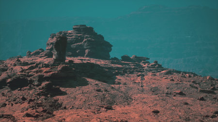 A breathtaking display of natures craftsmanship, a striking rock formation in vibrant red nestled within a majestic mountain range.の写真素材