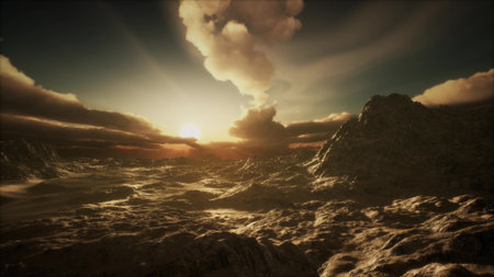 Golden sunlight bathes an expansive desert landscape, accentuating rocky terrain and dramatic clouds. The scene captures a moment of tranquility and beauty as day transitions to night.の写真素材