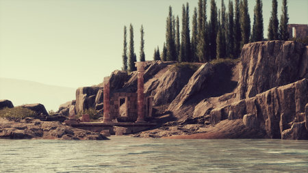The weathered remains of a Roman temple stand amidst rocky cliffs, partially submerged in water. Tall trees enhance the tranquil beauty of this historical site under clear skies.の写真素材