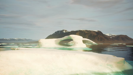 In a tranquil arctic scene, large icebergs glide gently on calm waters. Mountains rise in the...