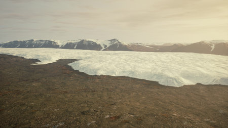 A massive glacier extends over rugged land, creating a striking contrast. In the background, snow...
