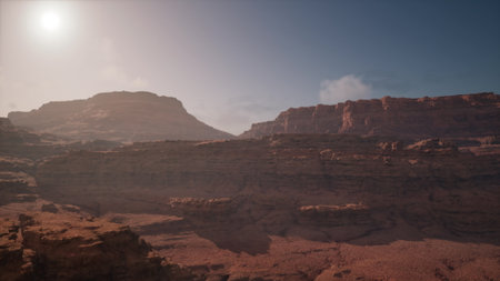 Deep canyons rise dramatically under the warm sunlight, casting shadows on rocky formations. The serene atmosphere invites exploration and adventure through the rugged terrain.の写真素材