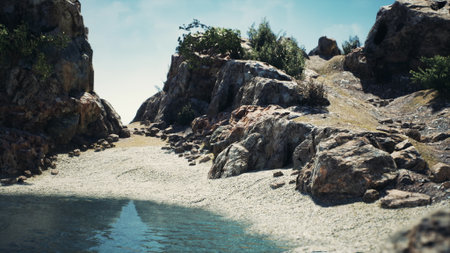 A tranquil scene showcases rugged rocks and a clear body of water nestled in a natural setting. Lush greenery flourishes under a bright blue sky, inviting peaceful contemplation.の写真素材
