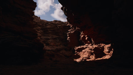 Breathtaking natural landscape reveals dramatic rock formations illuminated by sunlight. Shadows dance across rugged terrain, showcasing the beauty of this remote canyon at midday.の写真素材
