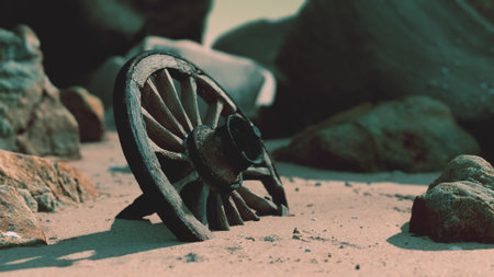 Amidst shimmering sands and rugged stones, a weathered wooden wheel leans against the earth, evoking tales of bygone journeys and craftsmanship under the fading light.の写真素材