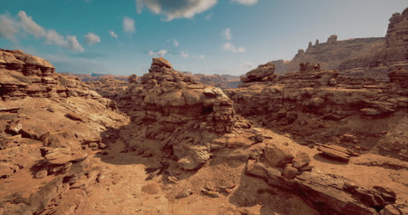 Vast desert landscape features towering rock formations and dry terrain. The clear blue sky highlights the natural beauty and unique geological structures found in this serene environment.の写真素材