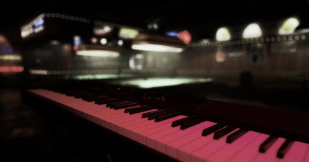A piano is positioned in the foreground, creating a musical backdrop in a dimly lit urban lounge. Soft lights illuminate the space, adding to the cozy atmosphere.の写真素材