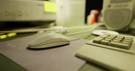 A close view of a computer mouse and keyboard on a desk. Office supplies and equipment are scattered...