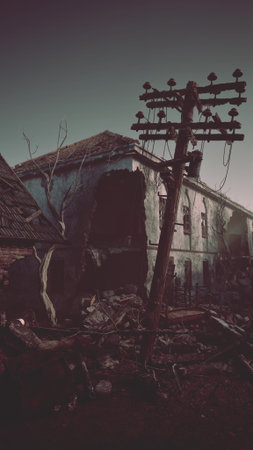 An old building stands abandoned with a telephone pole in front of it in a small town devastated by bombing.の写真素材