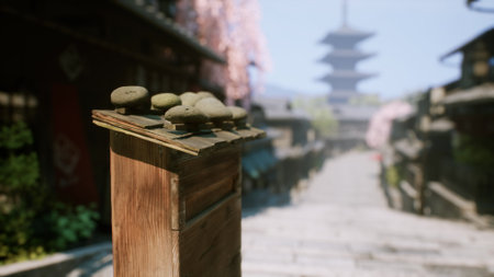 A beautiful cobblestone pathway winds through a serene town, flanked by cherry blossom trees in full bloom, leading to a majestic pagoda in the background.の写真素材