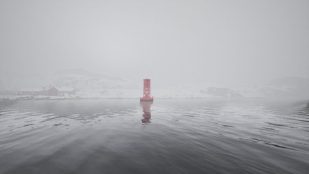 A vibrant red buoy stands alone in silent waters, surrounded by fog. The scene captures the essence of tranquility and isolation in a cold, serene environment.の写真素材