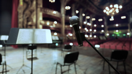 A beautiful theater prepares for an evening performance, with a microphone poised for action. Empty...