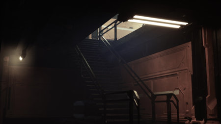 In a shadowy industrial space, a staircase rises toward a brightly lit area, hinting at activity above. The atmosphere feels mysterious and inviting, drawing one to explore.の写真素材