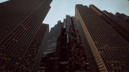 Skyscrapers adorned with glowing windows tower against a twilight backdrop. The urban canyon...