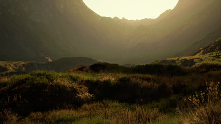 A breathtaking view captures the beauty of a valley at sunset. Gentle hills rise against the...