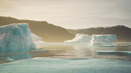 Majestic icebergs float serenely in still waters as the sun sets behind distant mountains, casting warm tones against the cool blues of the ice, creating a tranquil arctic scene.の写真素材