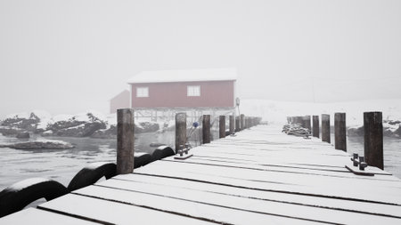 A quiet scene of a snow covered pier stretches toward a red cabin, surrounded by rocky shores and still waters. The winter fog adds a serene atmosphere to this remote location.の写真素材