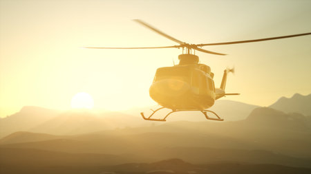 Golden rays of sunlight illuminate a helicopter as it ascends gracefully into the horizon. The silhouettes of mountains create a stunning backdrop, evoking a sense of adventure and freedom.の写真素材