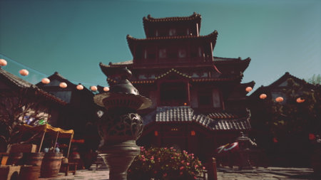 A beautiful ancient temple stands majestically against a clear sky, adorned with colorful lanterns. Visitors wander through the courtyard, enjoying the festive atmosphere and rich culture.の写真素材