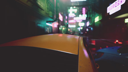 Colorful neon signs glow brightly in a lively city alley. Two parked cars are visible below the sparkling lights, creating a vibrant, energetic nighttime scene.の写真素材