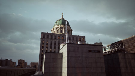 The green dome of a historic building rises above modern structures under a moody sky. Steel and concrete contrast sharply with the ornate architecture, creating a stunning city skyline.の写真素材