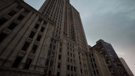 Tall architectural masterpiece stands against a moody sky as clouds gather, capturing the essence of urban life. Windows reflect the fading light of dusk and hint at stories inside.の写真素材