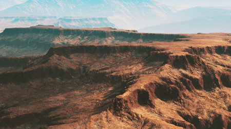 Majestic cliffs rise sharply from the earth, revealing intricate textures and colors under the blue sky. The vast, untamed landscape invites exploration and adventure.の写真素材