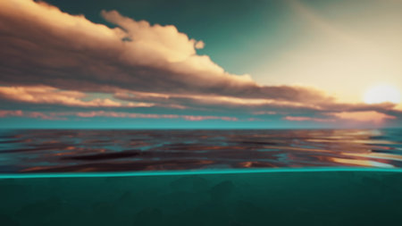 As the sun sets on the horizon, soft colors illuminate the sky and gently ripple through the ocean. A peaceful moment captures the serenity of nature at twilight.の写真素材