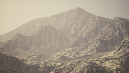 Breathtaking view of towering mountains with steep, rocky slopes. Golden light bathes the landscape, highlighting the intricate textures and colors of the natural rock formations.の写真素材