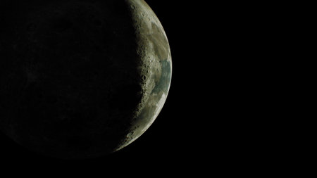 The partially lit lunar surface visible from spaceの写真素材