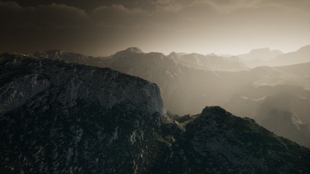 Quiet mountains stretch into the horizon as dusk settles over the rugged terrain, casting soft shadows that blend with the warm hues of the fading light, creating a serene ambiance.の写真素材
