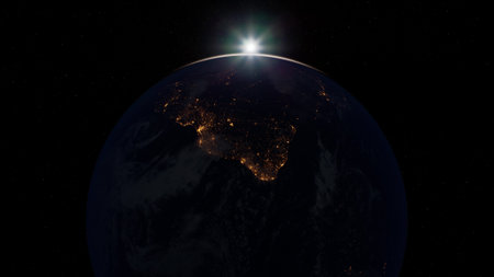 This captivating scene depicts Earth from space at sunrise, showcasing the glowing lights of India beneath the dark expanse. The interplay of light highlights the beauty of our planet.の写真素材