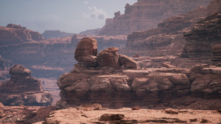 The scene captures majestic rock formations in a vast desert. Sunlight highlights the intricate details of the cliffs, creating shadows and depth. A peaceful atmosphere prevails.の写真素材