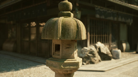 A weathered stone lantern stands tall in a tranquil garden, surrounded by ancient architecture and rocky features. The serene atmosphere captures a moment of peace and history.の写真素材